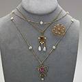 Late victorian and art nouveau jewelry three pieces two art nouveau pendants with pearls one with 41 chain the other with 15 chain late victorian ornate floral scroll pin with diamonds approx