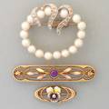 Three gold brooches 20th c enameled 14k yg and amethyst panel brooch by krementz ca 1910 14k wg with diamonds and pearls ca 1960 enameled pansy pin with pearl ca 1910 83 dwt longest 1
