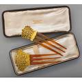 Two florentine style gold combs in tiffany box pierced and chased 14k yg crests above horn ca 1900 unmarked largest ornament 2 14 x 1 12 maroon leather and silk box marked tiffany  co 1