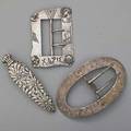 Three american silver novelties ca 1900 shiebler for tiffany  co homeric sash buckle george a henckel  co for je caldwell  co rococo sash buckle art nouveau embossed floral scent flask