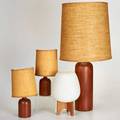 Danish etc three cylindrical teak table lamps unmarked together with a laurelstyle lamp marked yugoslavia largest 32 x 6 dia