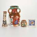 George johnson four polychrome decorated pieces urn bud vase covered jar and coaster all signed largest 11 18 x 7 12 dia