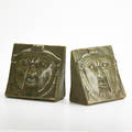 Fulper pair of aztec mask bookends in mission verde glaze flemington nj 19101915 both inkstamp marked paper label to one each 5 12 x 5 34 x 3