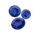 Three unmounted faceted tanzanites round brilliant cut 51 cts 10 mm round brilliant cut 949 cts 1239 mm oval 990 cts 1457 x 11 mm 2449 cts tw