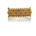 Victorian etruscan revival jeweled gold bracelet broad hinged bangle elaborate concentric geometric granulations and cannetille work accented by bezel set faceted blue sapphire and seed pearls 15k