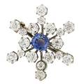 Diamond and natural blue sapphire starburst brooch 18 oec diamonds on knife edge rays approx 6 cts tw surround a cushion cut blue sapphire approx 2 cts 14k yg wg plated hinged bail inscri
