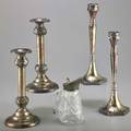 Weighted silver candlesticks and a syrup jug five pieces pair of candlesticks with acanthus knob design on finial pair of candlesticks with graduated finial and hexagonal base syrup jug featuring