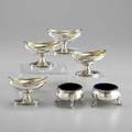 Six georgian silver salts set of four boatshaped footed master salts by john emes london 1804 monogram r 2 12 x 3 58 pair of padfooted circular salt cellars with cobalt glass inserts lond