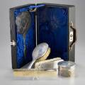 Chinese export silver vanity set five pieces cylindrical powder jar two brushes hand mirror and comb in fitted case scenic chasings depict nobility and domestic pursuits zeesung 20th c monogr