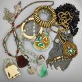 Grand tour souvenir jewelry fourteen pieces total nephrite silver jade and pieces of asian interest two north african crosses gilt brass bracelet indian garnet necklace and krishna amulet iran
