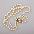 Double strand cultured pearl necklace two concentric graduated strands of cultured saltwater semispherical pearls 10 mm  5 mm joined by 14k yg pearl and multi gem clasp accommodates 14 