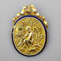 Romantic revival 18k yellow gold and enamel brooch with ribbon bow surmount and embossed scene including cupid and doves blue and white enamel surround apparently unmarked 2 x 1 18 87 dwt