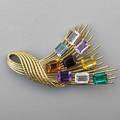 Multi gem 18k gold spray brooch eight rectangular step cut gems include tourmaline citrines garnet blue topaz and quartz on twisted 18k yg wires with trumpet clasp ca 1970 marked 18k 2 34 x