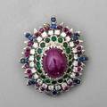 Precious gemstone and diamond 18k gold pendant steep oval cluster in the florentine style central ruby cabochon 19 cts by formula framed by rows of faceted emeralds rubies sapphires and diamond