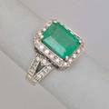 Contemporary emerald ring with diamonds rectangular faceted emerald 385 cts by formula diamond halo and split shank chased hoop diamonds approx 40 ct tw in 14k wg size 7 48 dwt