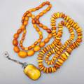 Butterscotch amber jewelry three pieces strand of variegated oblate amber beads 258 mm 24 strand of tumbled pebbles 26 baltic silver pendant mounted with cushionshaped amber cabochon 45 x