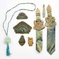 Jade or hardstone carved group eight pieces 19th20th c fish and dragon motif buckle and two chinese jade swords etc longest 12 12