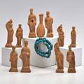 Egyptian ushabti etc twelve pieces eleven terra cotta figures or phylactery vials together with turquoise dyed faience bracelet tallest 6 12