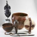 African decorative group seven pieces 20th c west african redware bowl three wood masks carved wooden bowl and two iron copies of sword currency unmarked tallest 17