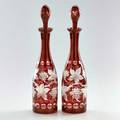 Bohemian glass pair of ruby cut to clear bottles with stoppers decorated with grapes and grapevines early 20th c both unmarked 16 x 3 34 dia