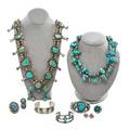 Native american jewelry nine items include silver and turquoise squash blossom necklace two cuffs navajo ring etc 20th c necklace 26