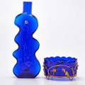 Blenko etc blue blenko abstract bottle together with art nouveau cobalt blue glass bowl encased in gilded metal floral decoration 20th c blenko with paper label bottle 16