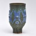 Edwin and mary scheier tall footed coupe with peaking figures in gunmetal and blue glazes green valley az illegible mark 15 x 8 12 dia