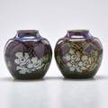 Royal doulton pair of bulbous vases in purple and dark green glazes decorated with wild white roses england 19021922 both have impressed mark each 5 34 x 4 12 dia provenance victoria an