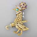 Jeweled bicolor 18k gold mother goose brooch whimsically sculpted goose with umbrella trimmed in wg set with diamonds approx 12 cts tw bonnet with bezel set rubies turquoise eyes ca 1960 ma
