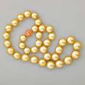 Golden south sea pearl and coral necklace gia report 2155246107 describes 35 round pearls 145  1108 mm cultured saltwater no indications of treatment strong yellow natural body color melon