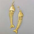 Tiffany  co 18k gold fish skeleton earrings articulated suspend from fish hooks ruby eyes 20th c each fish marked  t  co 750 2 34 135 dwt