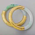 Two chiseled gold jade hinged bangles 14k gold chased with chinese motifs mid 20th c unmarked 2 14 interior diameter