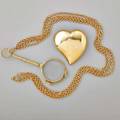 Twentieth century gold jewelry austrian 14k yg lorgnette on 10k gold long chain ca 1925 14k gold puffed heart broochpendant ca 1980 heart 2 14 x 2 18 48 dwt gw
