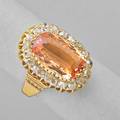 Imperial topaz and diamond 15k gold ring oval faceted topaz 6 cts by formula framed by a line of omc diamonds 1 cts tw embossed shoulders ca 1900 size 7 6 dwt
