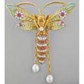Masriera pliqueajour jeweled 18k wasp brooch hovering and clutching a diamond translucent enameled wings and articulated body set with rows of diamonds and rubies suspends two oblate pearls on pa