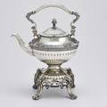 Je caldwell coin silver kettle on stand halfreeded with applied egg and dart ribbons engraved strap decorations cast lion head and acanthus cast handle ivory insulators neoclassical bracket st
