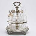 John c moore sterling seven bottle cruet frame oval with acanthus and bead borders open loop plume handle anthemion bracket feet tiffany  co 1853 supports seven hexagonal balustershaped cut