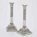 Tiffany  co sterling repousse candlesticks halfreeded and floral columns below lotus leaf nozzles on square stepped foot wood weighted second half of 20th c 11