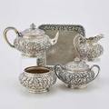 Peter l krider repousse silver tea service four piece chased with dense blossoms and tobacco leaves teapot creamer sugar and waste bowl monogrammed under base and dated 1886 801 cushionshape