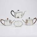 Three george iii silver teapots and a stand oval teapots with bright cut decoration wood finials and handles possibly george smith 1788 r  d hennell 1796 wm sutton 1790 oval teapot stand