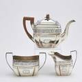 George iii three piece silver tea service vertically lobed cushion forms with chased decorative motifs wood pineapple finial two smaller elements inscribed on base money left by lydia willard to l