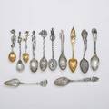 Twelve extraordinary figural silver spoons three by gorham narragansett with crab whaling with ship handle casa grande arizona with cactus handle parcel gilt leaf and guitar attrib continenta