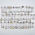 Sixty four silver souvenir spoons includes silver gilt enameled egyptian revival examples one with pharaoh and pyramids one with palm tree brooklyn bridge san francisco by international silver c