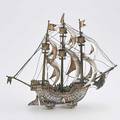 Ludwig neresheimer 800 silver nef designed as a wheeled galleon with billowing sails inhabited by four sailors dolphinform hubs deck detaches to expose bowl on wheels ca 1890 12 12 x 14 32