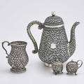 Fine indopersian silver holloware four pieces gourdshaped coffee pot on ring foot with ivory insulators 9 34 bulbous mug with double scroll incised floral handle 4 34 and spherical footed
