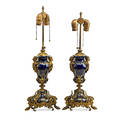 Pair of sevres porcelain lamps giltbronze mounted cobalt ground with gilded highlights early 20th c 24