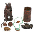 Chinese scholars objects eight one brushholder seal carved wood figure carved cloudbank bronze cat carved peachstone jadeite necklace and one russet jade pendant 19th20th c brushpot 5 1