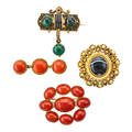Four victorian coral or hardstone brooches three oxblood coral buttons in roped bar oval oxblood coral cluster revivalist style black enamel and malachite beads gold foiled and agate etruscan revi
