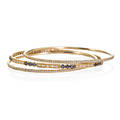 Three delicate round gold diamond bangles two concentric diamond thread bangles one concentrically set with rows of rbc diamonds and sapphires approx 220 cts tw 14k yg ca 2000 accommodate 7