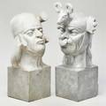 Two gargoyle sculptures of heads